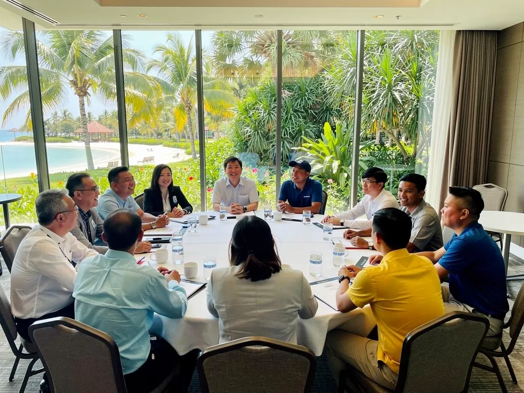 Corporate team building meeting at Sentosa Island, Singapore, with a view of the beach.