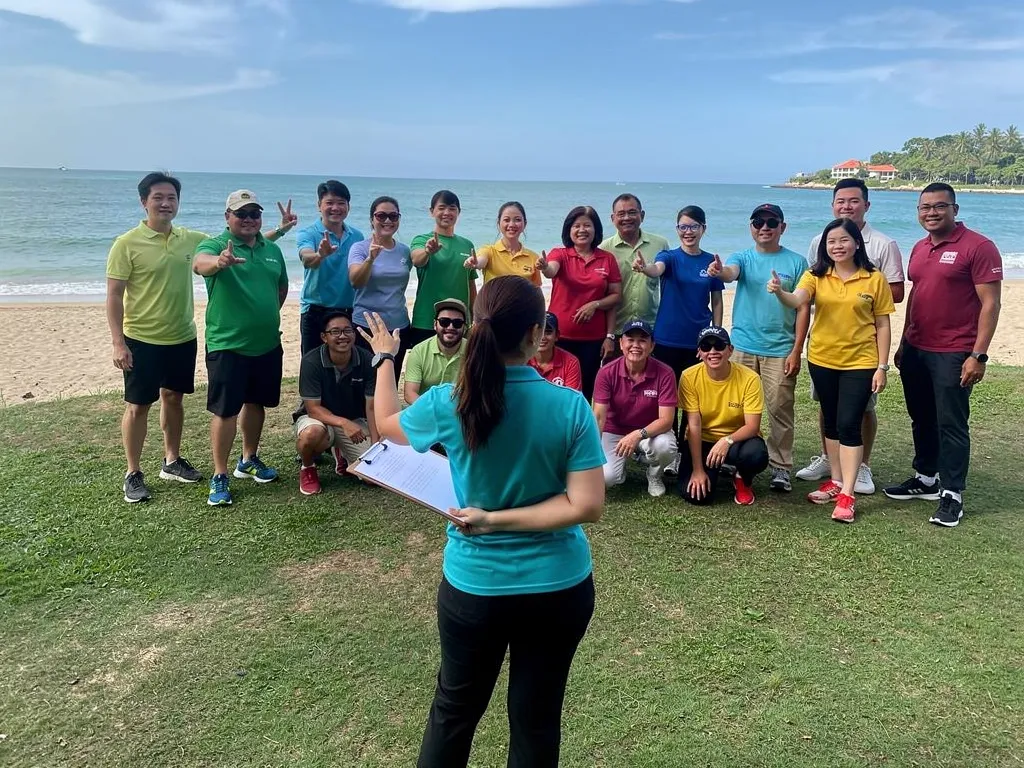 Facilitator coordinating logistics for a corporate island event