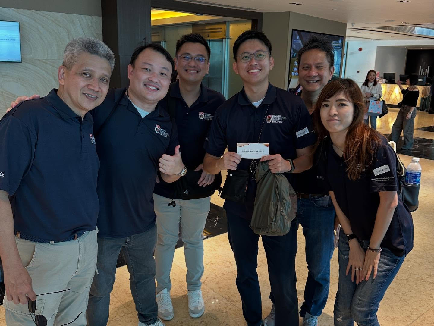 Large group of colleagues posing together at a team building session